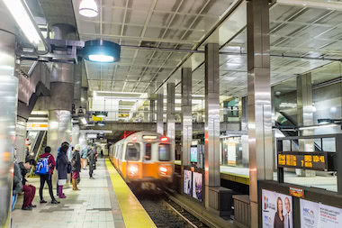 People waiting as orange line train arrives inside North Station