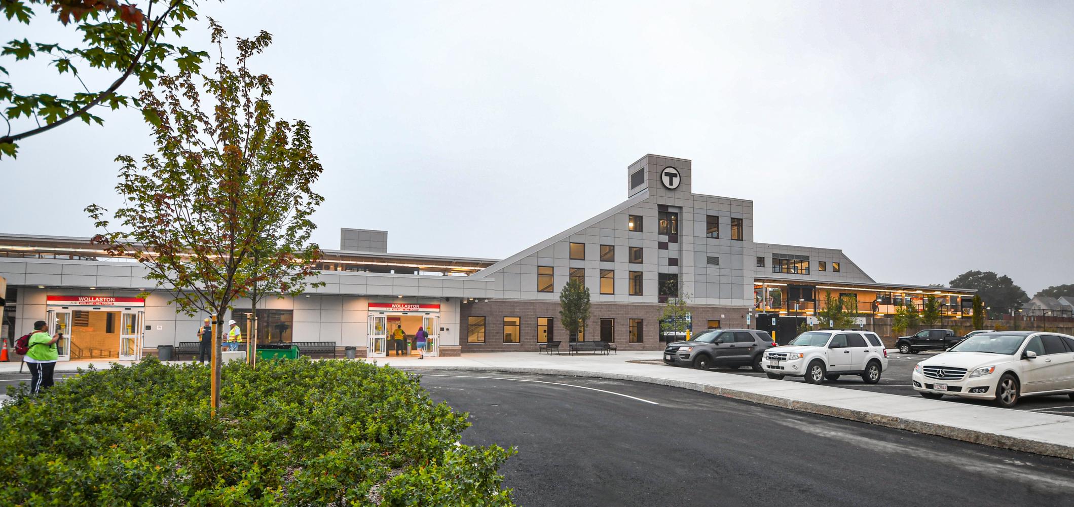 The building facade of the newly renovated Wollaston Station, viewed head on from the new parking lot.