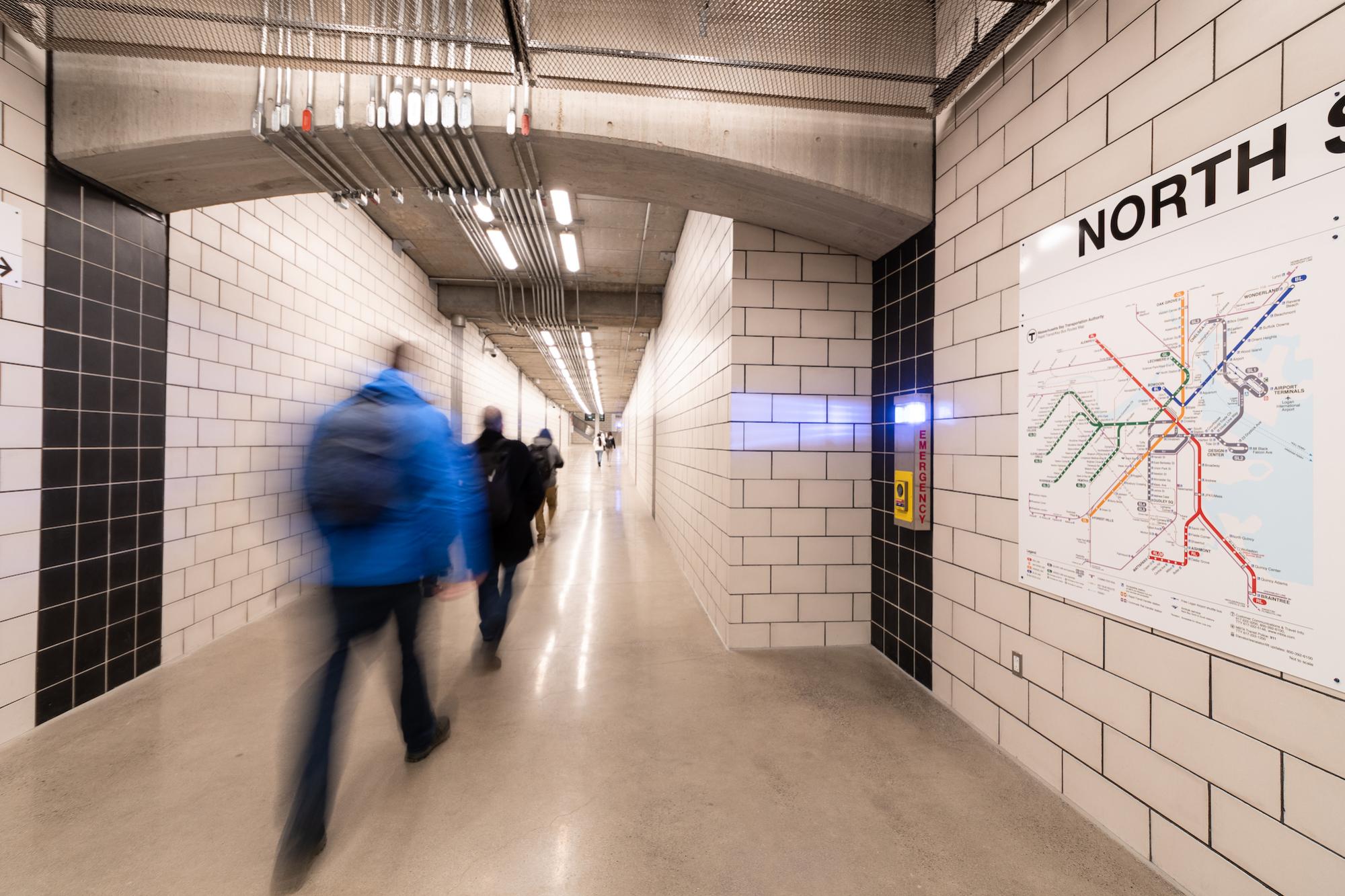 Riders traverse the new North Station underground walkway