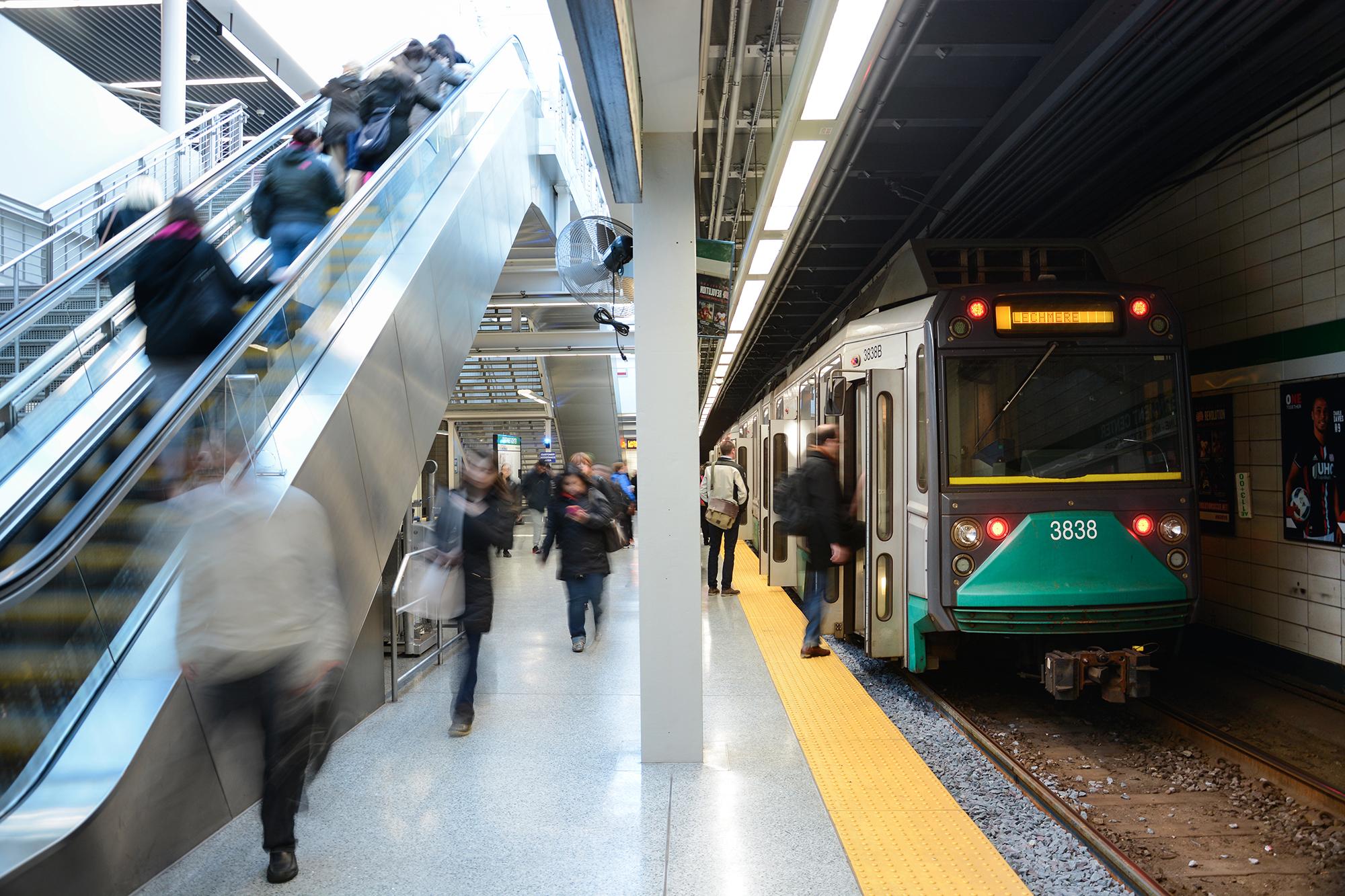 Passengers on the Green Line platform at Government Center, as a train boards