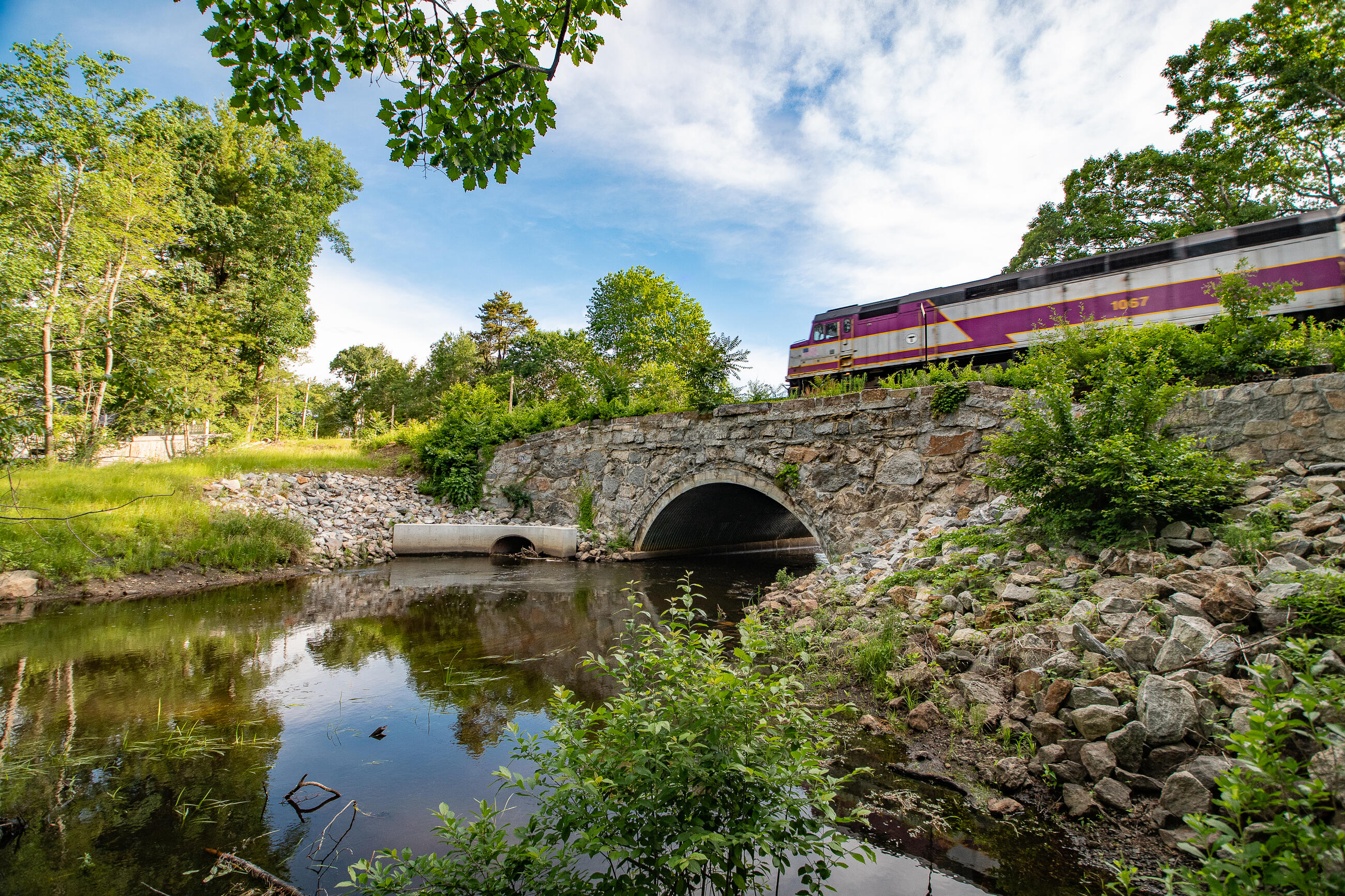 Commuter Rail passing over Shawsheen River Bridge and waterway