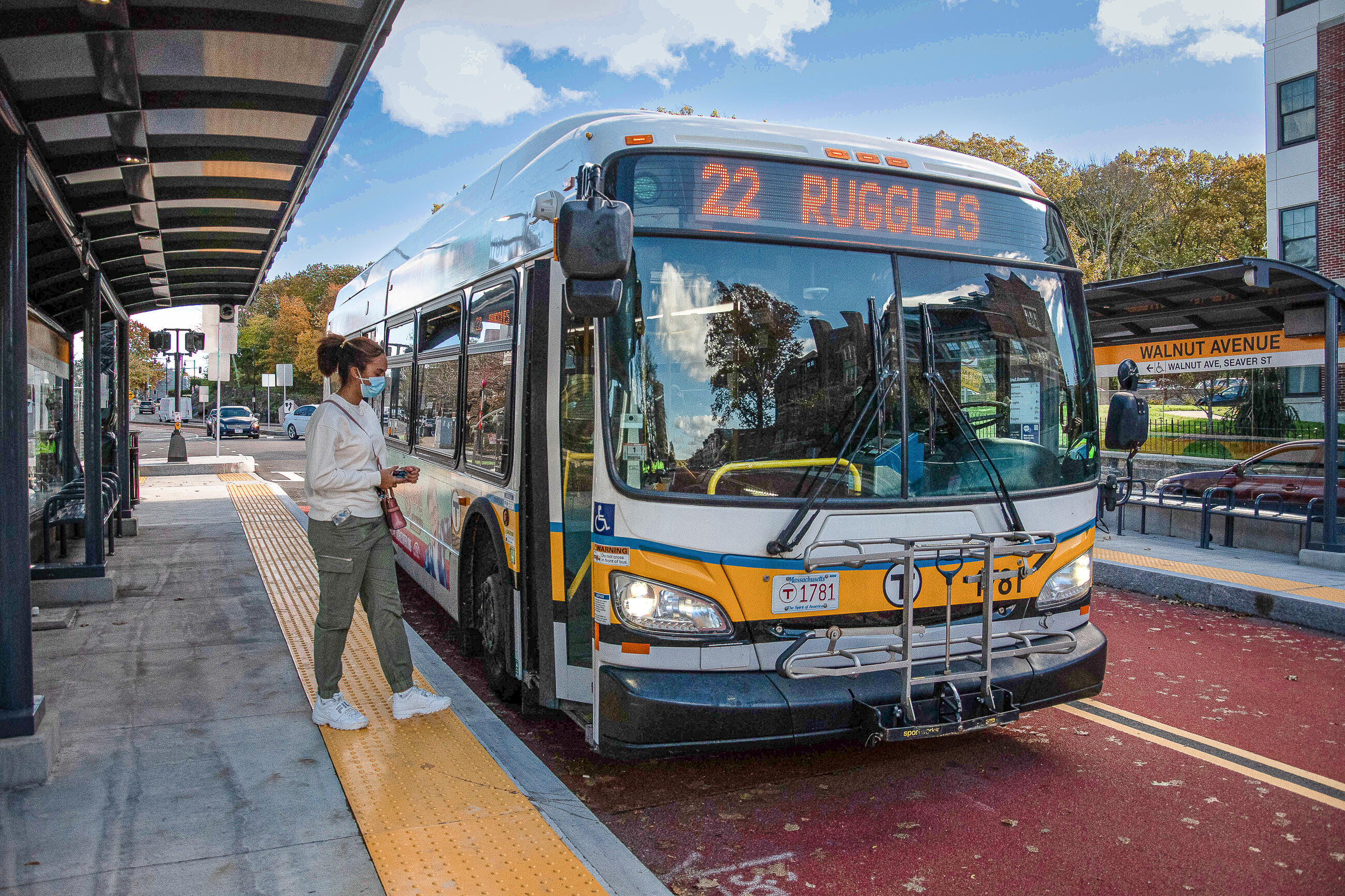 a rider boards a Route 22 bus at Walnut Avenue stop along Columbus Avenue bus lane