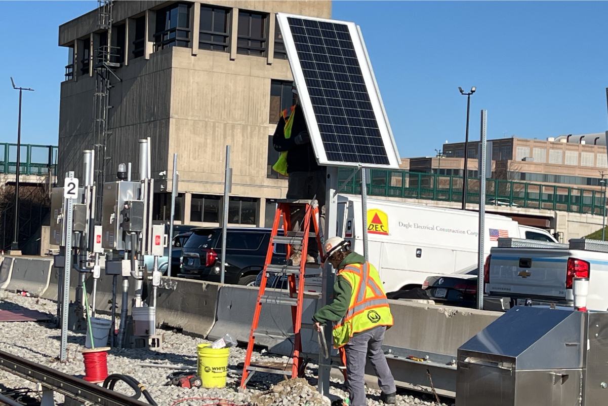 two crew members working on a solar panel 