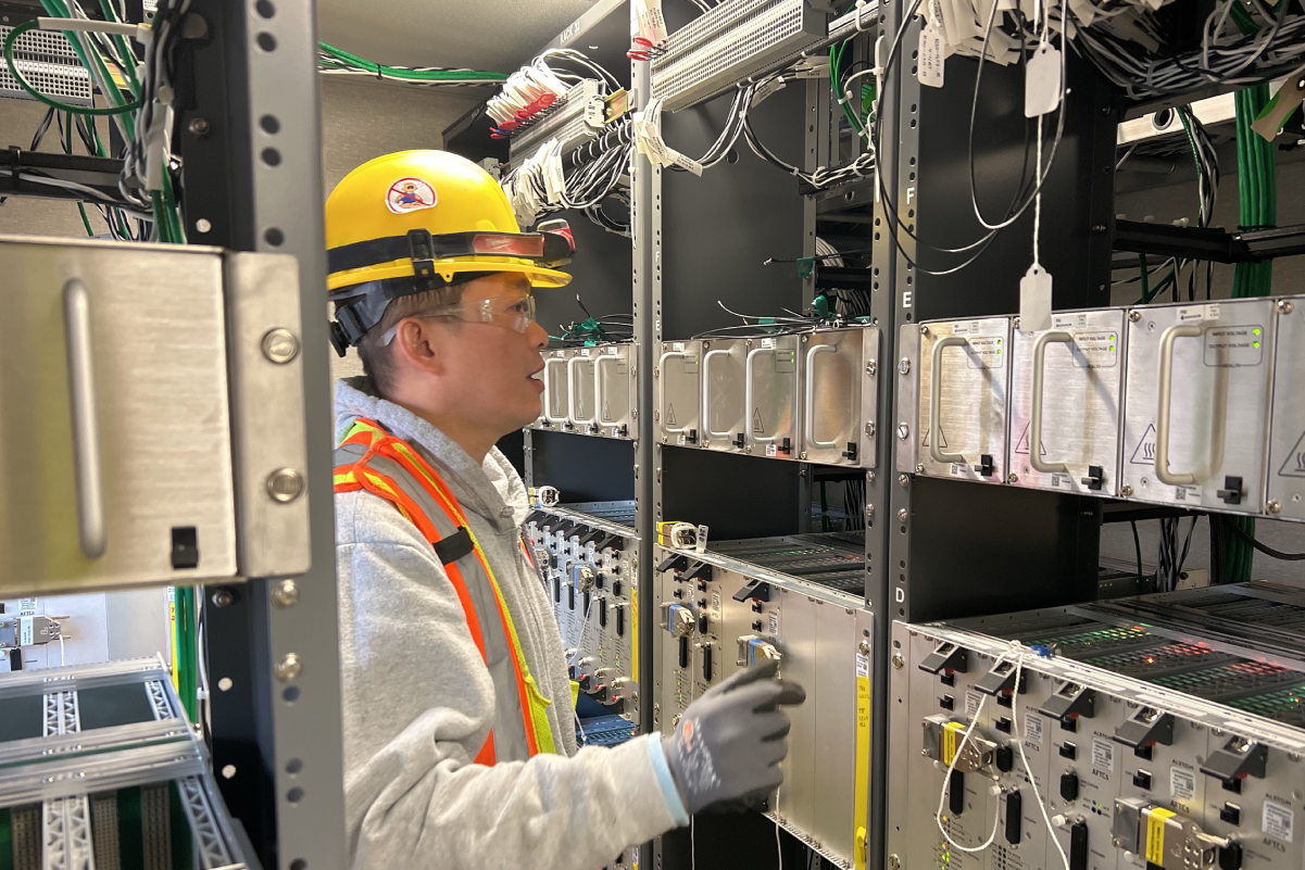 crew member looking at racks of wires