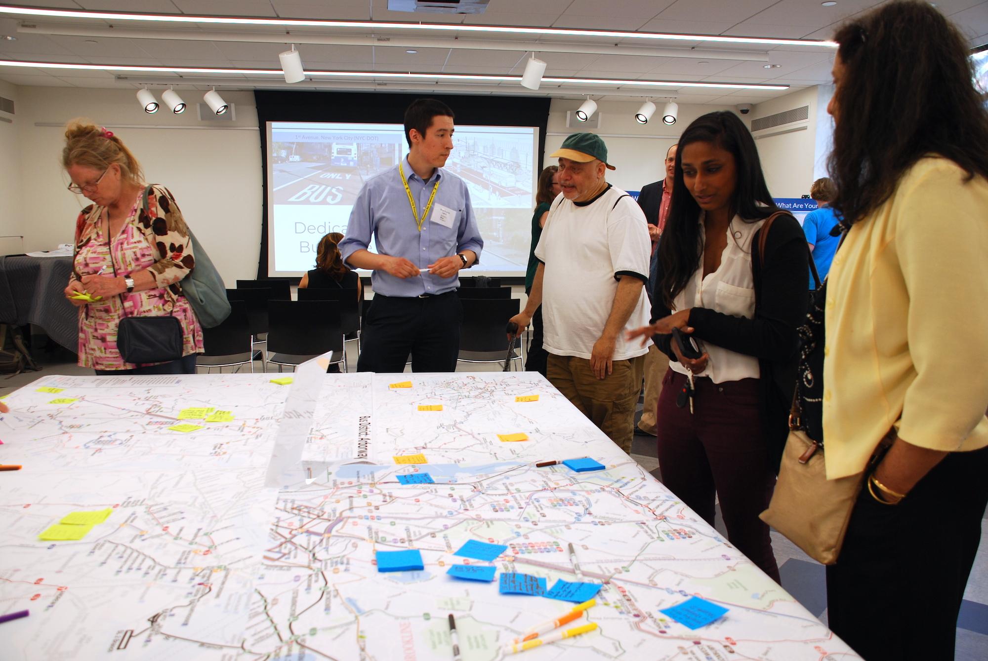 A group of community members discusses their ideas for better bus service at a Better Bus Project public meeting.